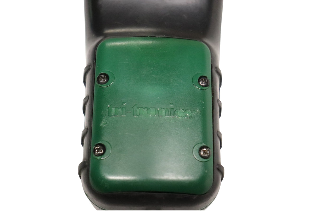 Close-up of Tri-Tronics G3 EXP transmitter battery cover and mounting screws